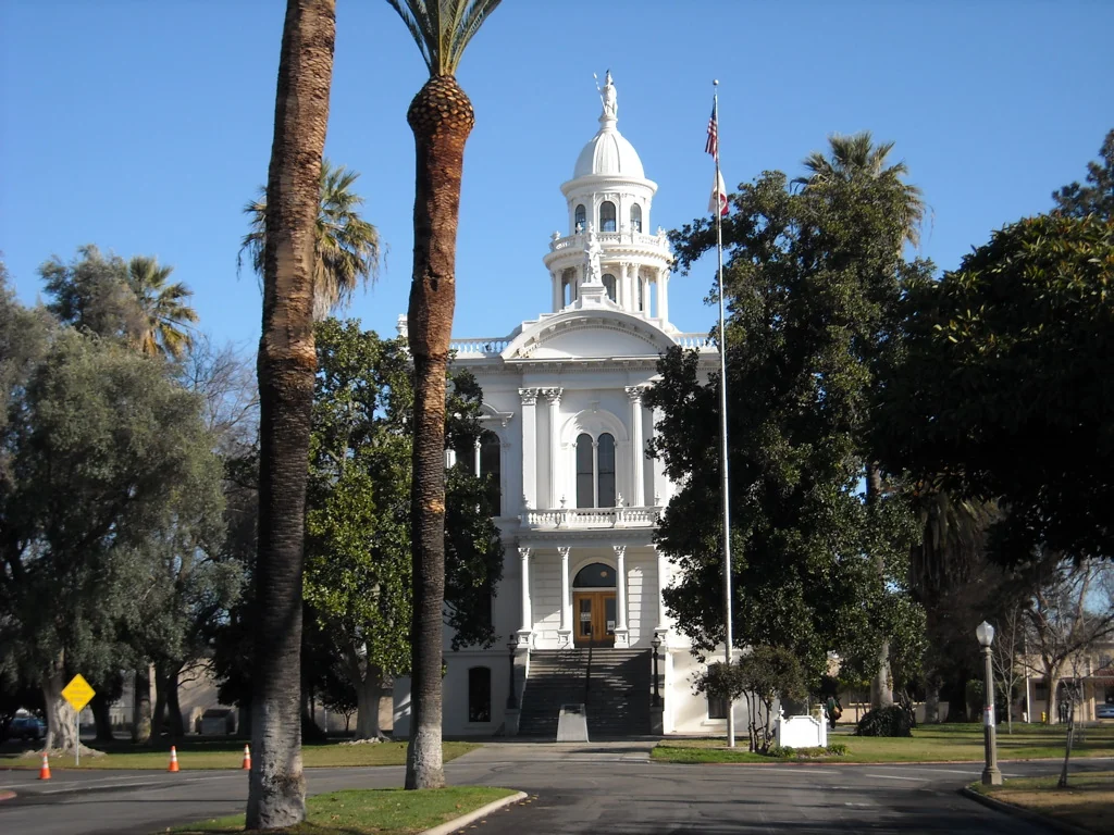 Merced's white historic courthouse and domed cupola framed by palms and mature trees Destination photo. Not the club or its route.